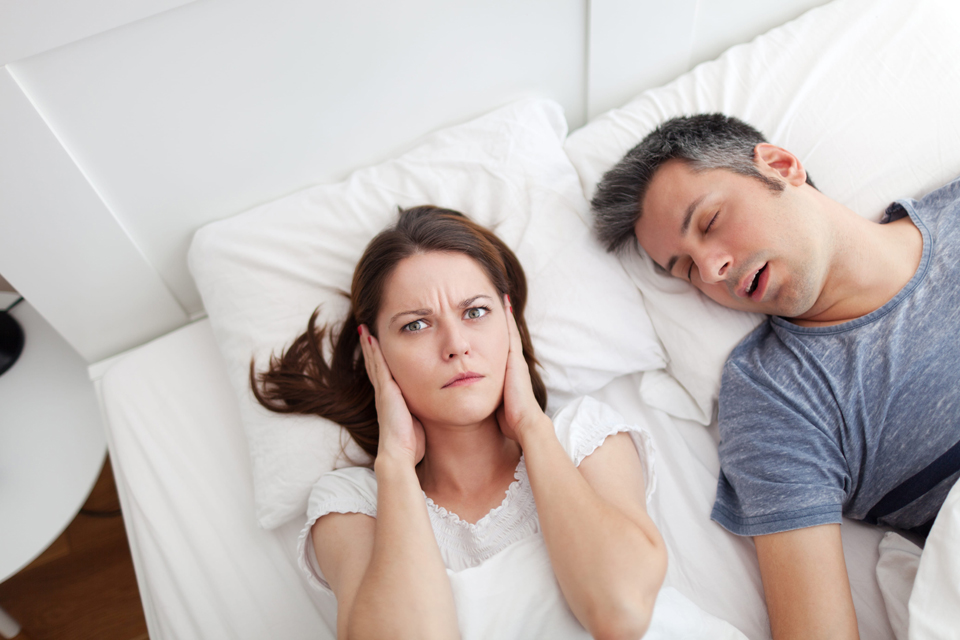 Woman struggling to sleep becasue husband is snoring